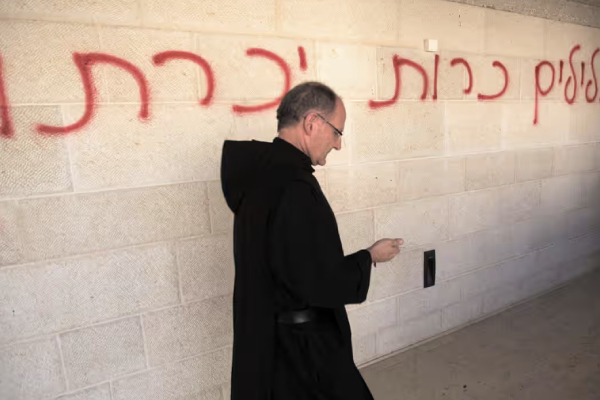 A priest walks past Hebrew